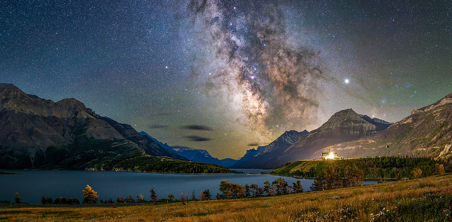 Milky Way arching over a mountain lake at night — illustrating dark-sky advocacy